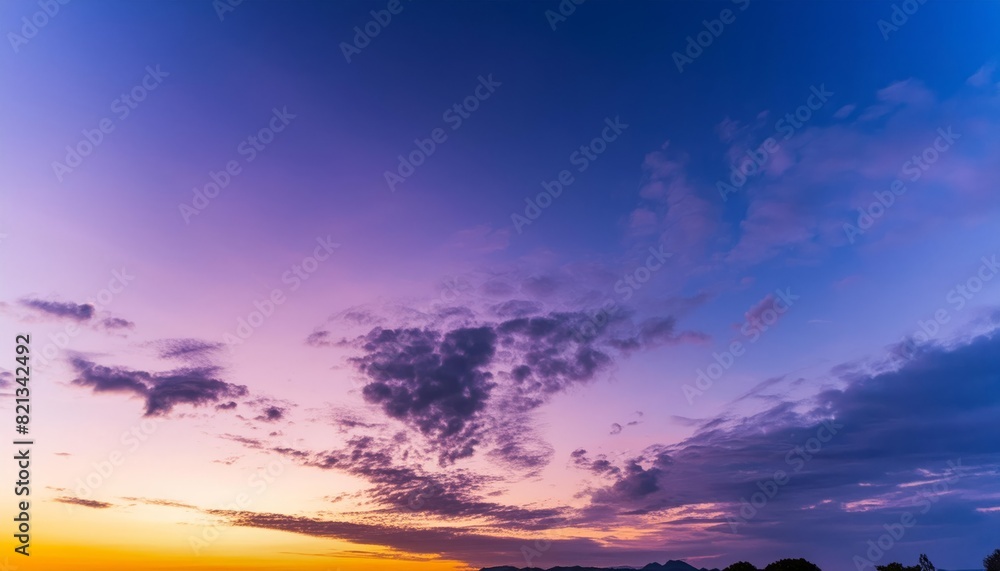 Vibrant sunset hues blending into twilight over a serene landscape