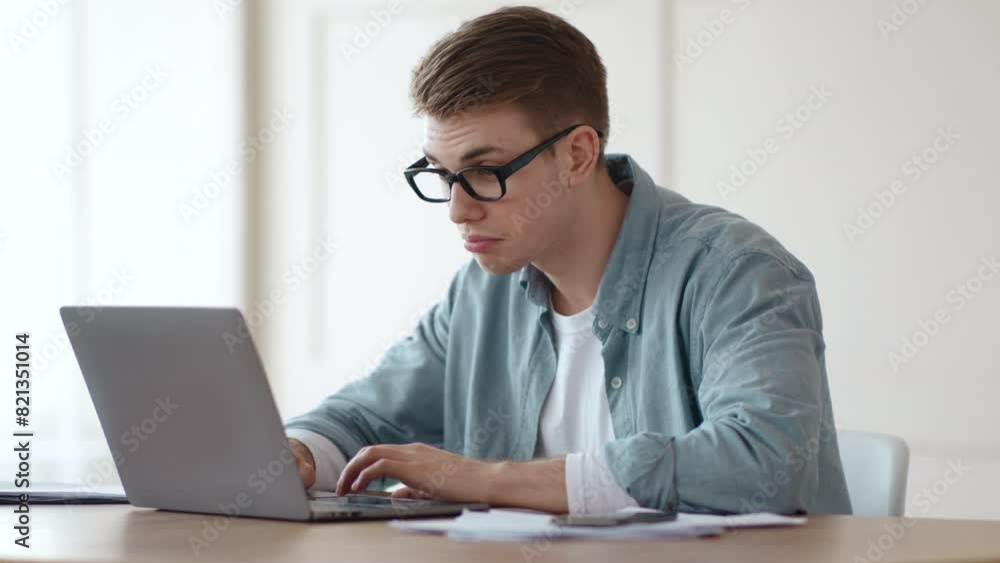 Self-education on quarantine. Young guy watching tutorials online on laptop at home office Self-education on quarantine. Young guy watching tutorials online on laptop at home office