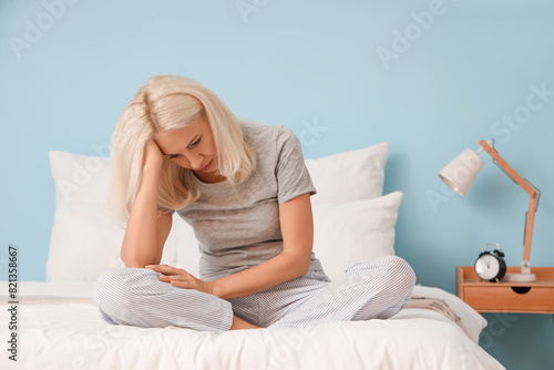Depressed mature woman sitt...