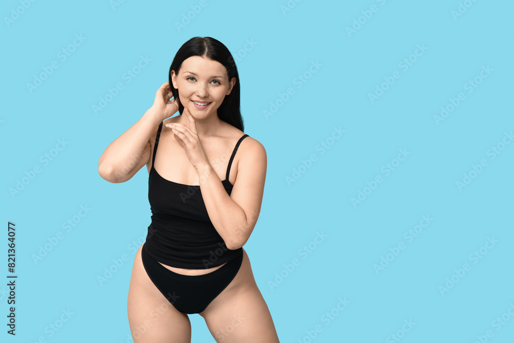 Obraz premium Body positive young woman on blue background
