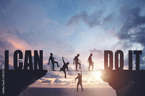 Silhouettes of people walking on a rope between rocks, success concept