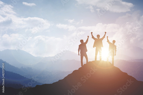 Silhouette of a team celebrating a victory against sunset background, concept of victory and leadership