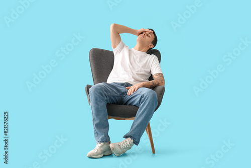Tired young man sitting in ...