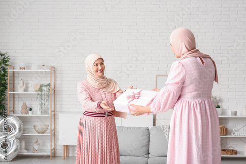 Muslim adult woman greeting...