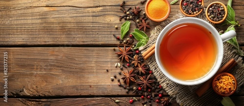 A cup of tea surrounded by spices and herbs photo