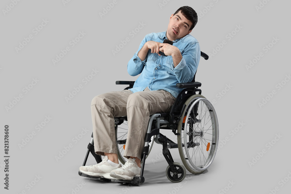 Young man in wheelchair on light background. National Cerebral Palsy Awareness Month