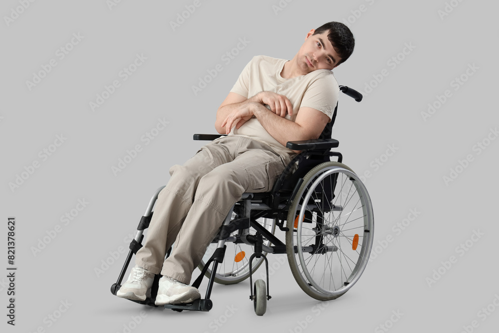 Young man in wheelchair on light background. National Cerebral Palsy Awareness Month Young man in wheelchair on light background. National Cerebral Palsy Awareness Month