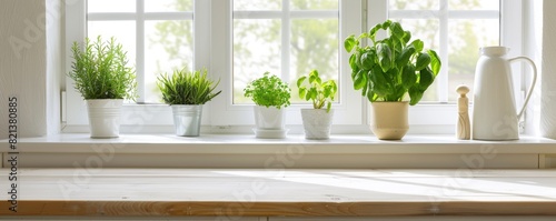 White wooden table in kitchen with green plant on the window