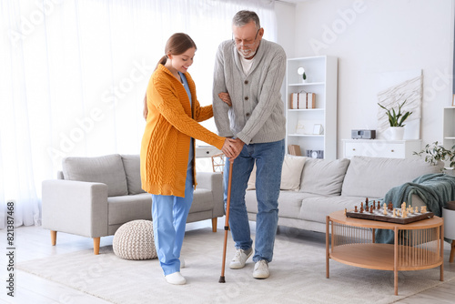 Female caregiver helping se...