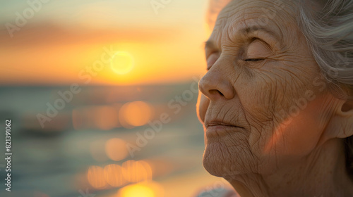 A woman is sitting on the beach  looking at the sun