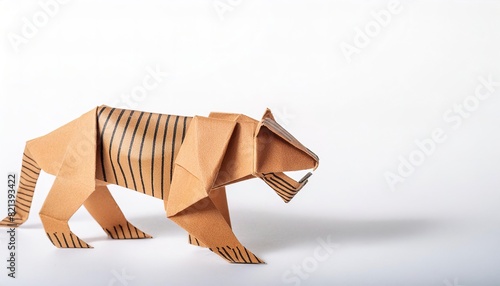 Animal extinct mammal concept origami isolated on white background of a saber toothed tiger, with copy space, simple starter craft for kids photo