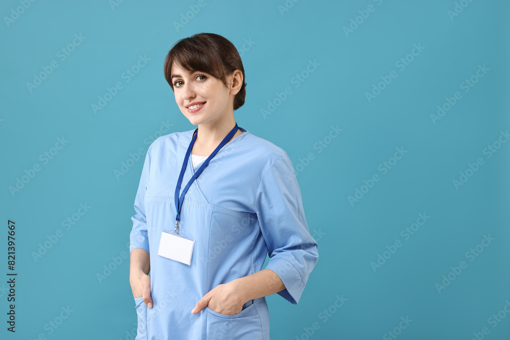 Portrait of smiling medical assistant on light blue background. Space for text Portrait of smiling medical assistant on light blue background. Space for text