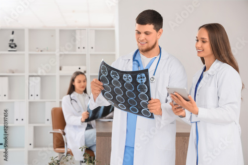 Medical team collaboration, doctors examining brain scan x-ray, healthcare pr...