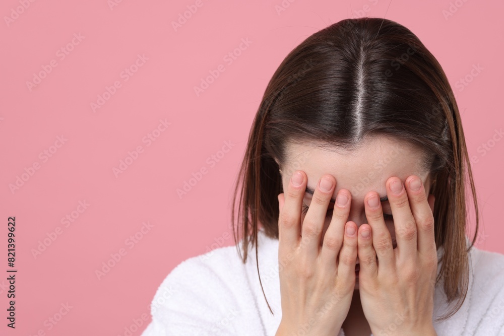 Woman suffering from hair loss problem on pink background. Space for text Woman suffering from hair loss problem on pink background. Space for text