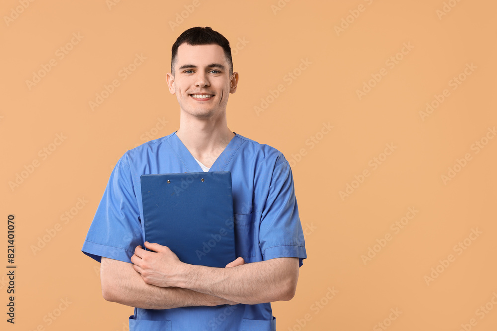 Portrait of smiling medical assistant with clipboard on beige background. Space for text Portrait of smiling medical assistant with clipboard on beige background. Space for text