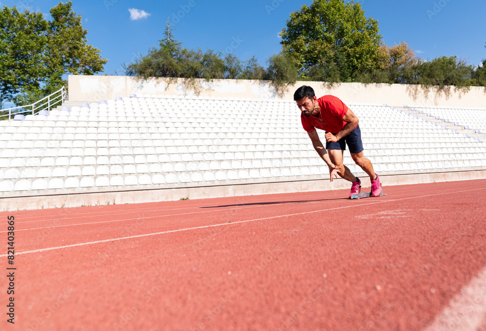 Stadium, man running and start block of athlete on a runner and arena track for sprint