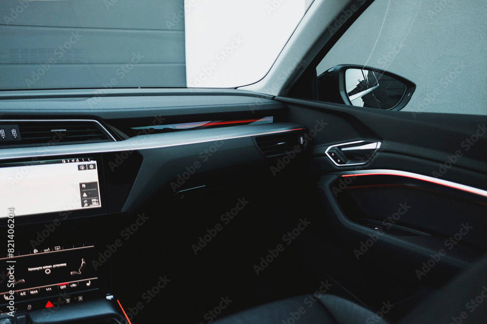 Modern black subcompact electric crossover SUV with black interior. Details interior. Modern black subcompact electric crossover SUV with black interior. Details interior.