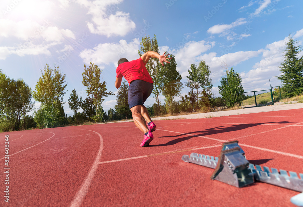 Stadium, man running and start block of athlete on a runner and arena track for sprint