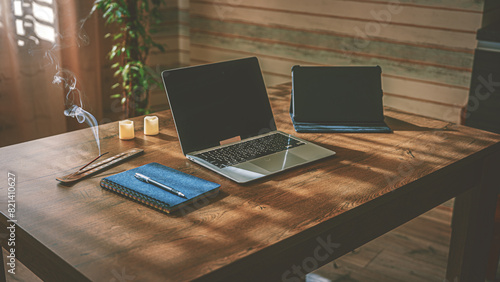 Home Office. Organization of the workplace. On the table there is a laptop, a tablet and a blue notebook with a pen for notes