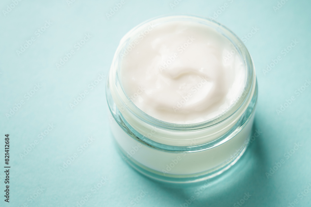 Cream jar on blue background. Skin care product. Close up. Cream jar on blue background. Skin care product. Close up.