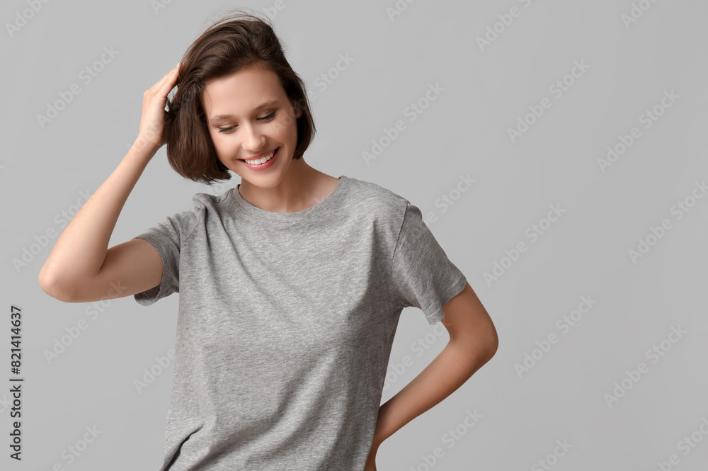 Beautiful young happy woman with bob hairstyle on grey background Beautiful young happy woman with bob hairstyle on grey background