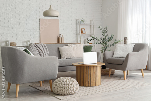 Wallpaper Mural Stylish interior of living room with cozy sofa, armchairs, coffee table, laptop and olive tree Torontodigital.ca