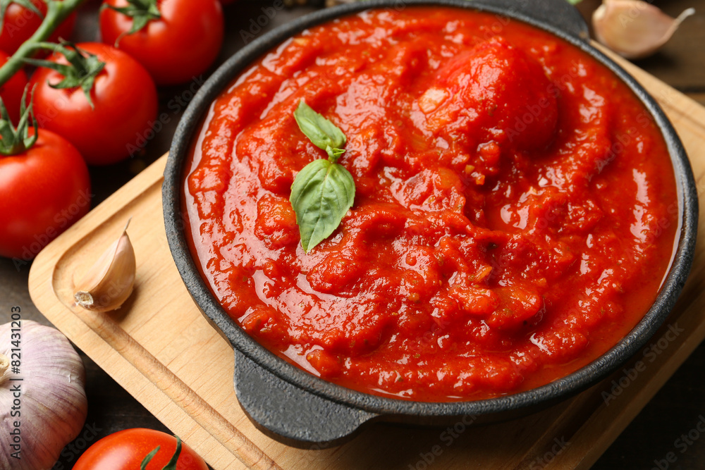 Homemade tomato sauce in bowl and ingredients on table, closeup Homemade tomato sauce in bowl and ingredients on table, closeup
