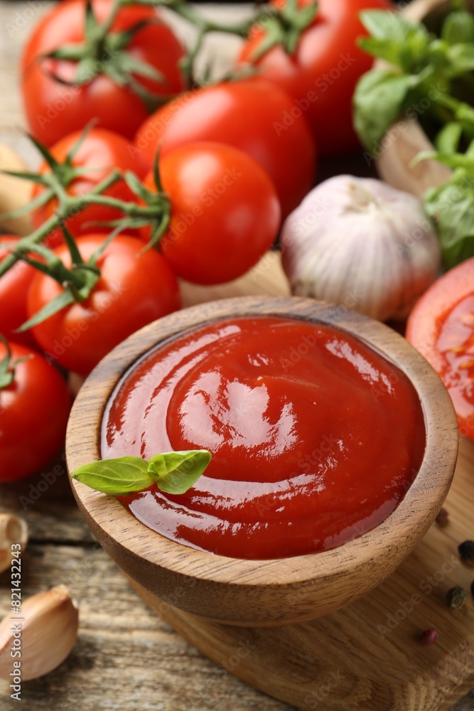 Tasty ketchup, fresh tomatoes, basil and spices on wooden table Tasty ketchup, fresh tomatoes, basil and spices on wooden table