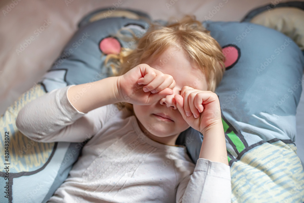 Little Girl Laying on Bed With Hands on Face Little Girl Laying on Bed With Hands on Face
