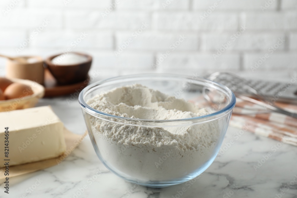 Making shortcrust pastry. Flour in bowl and butter on white marble table Making shortcrust pastry. Flour in bowl and butter on white marble table
