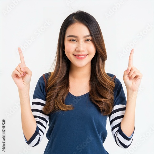 Beautiful young Asian woman pointing up to copy space and looking at camera with smile face and happy Pretty girl act like a satisfied product, use for advertising with isolated on white background