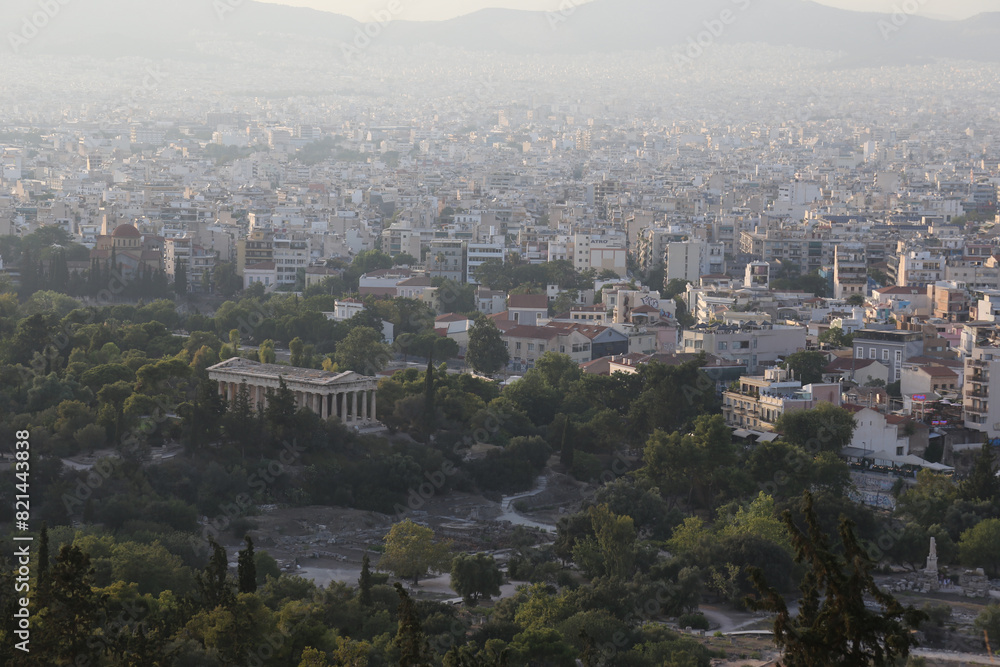 The Temple of Hephaestus with the city of Athens, Greece, behind it. The Temple of Hephaestus with the city of Athens, Greece, behind it.