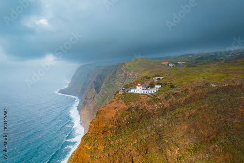 Lighthouse on rocky coast of beautiful island of Madeira in Portugal. Aerial view