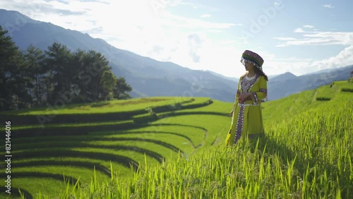 A farmer woman with fresh paddy rice terraces, green agricultural fields in countryside or rural area of Mu Cang Chai, mountain hills valley in Asia, Vietnam. Nature landscape. People lifestyle.
