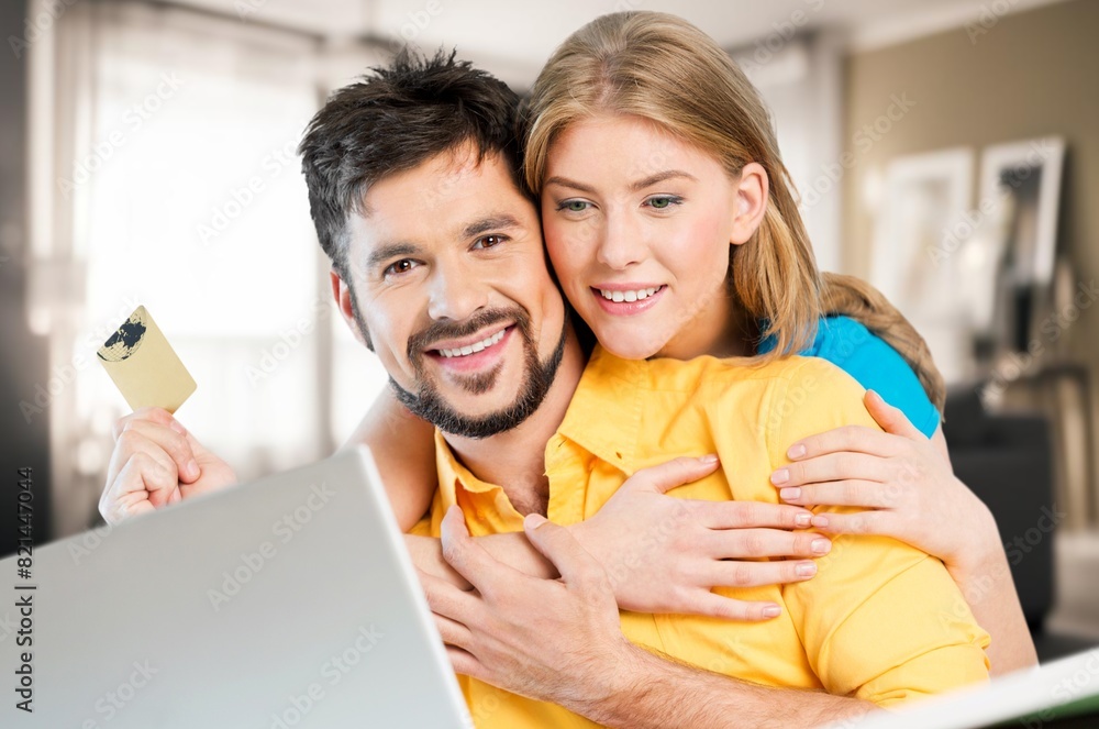 Fototapeta premium Cheerful young lovely couple use laptop