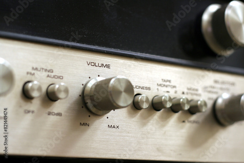 A close-up of a vintage style amplifier, with the focus on the volume switch.