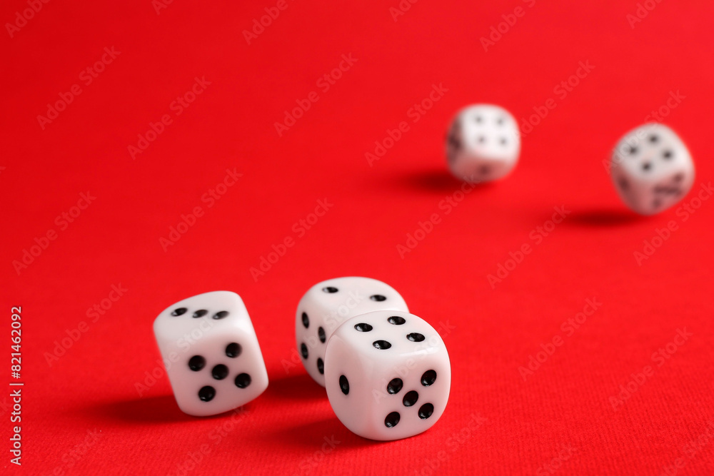 Many white game dices falling on red background. Space for text Many white game dices falling on red background. Space for text