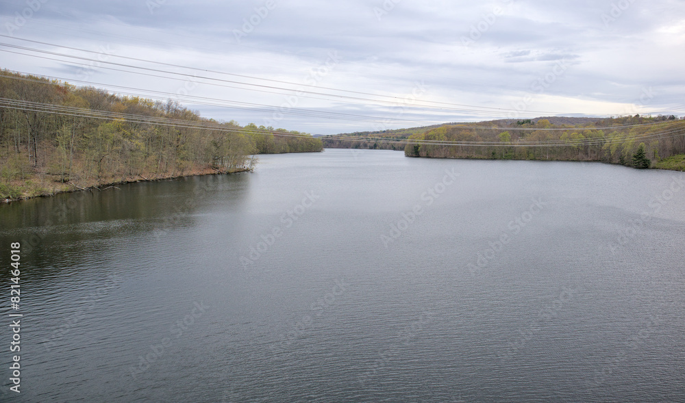 view of new croton aqueduct with power lines from railroad trestle (walking pedestrian cycling path on empire state trail putnam railroad) trees water pond lake scenic hiking travel view of new croton aqueduct with power lines from railroad trestle (walking pedestrian cycling path on empire state trail putnam railroad) trees water pond lake scenic hiking travel