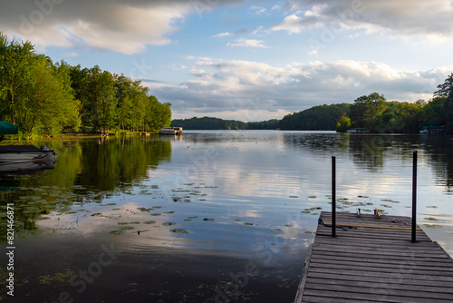 Looking out onto a Wisconsin northwoods lake as the last rays of sunlight begin to fade.  Many boats have returned from fishing.