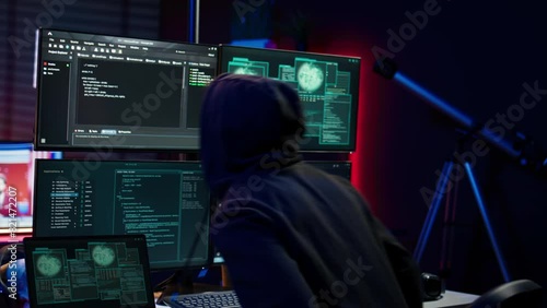 Hacker arriving in hidden underground shelter with laptop, prepared to launch malware attack on websites. Scammer in apartment starting work on dangerous script that can breach security, camera B photo