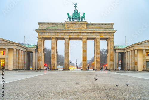 The Brandenburg Gate stands prominently at dawn, the early light accentuating its historic architecture. Berlin, Germany