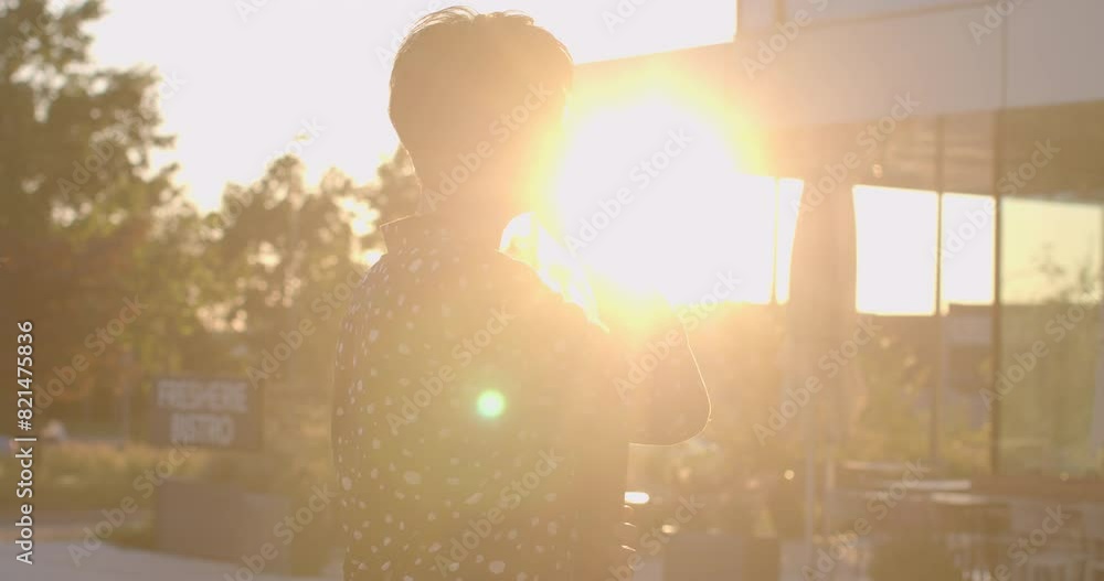 Anticipation of a meeting in the warm glow of the sunset. Businesswoman talking on phone. Concept of business, waiting, professionalism, and urban lifestyle. Anticipation of a meeting in the warm glow of the sunset. Businesswoman talking on phone. Concept of business, waiting, professionalism, and urban lifestyle.