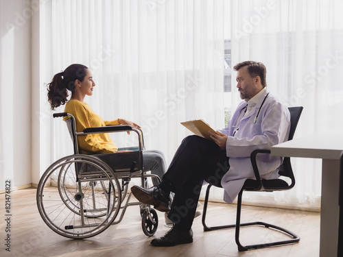 Portrait health care latin american woman sick sit wheelchair with man doctor caucasian two people check and treat patients talk help support explain medicine sick person inside hospital clinic room © Singh