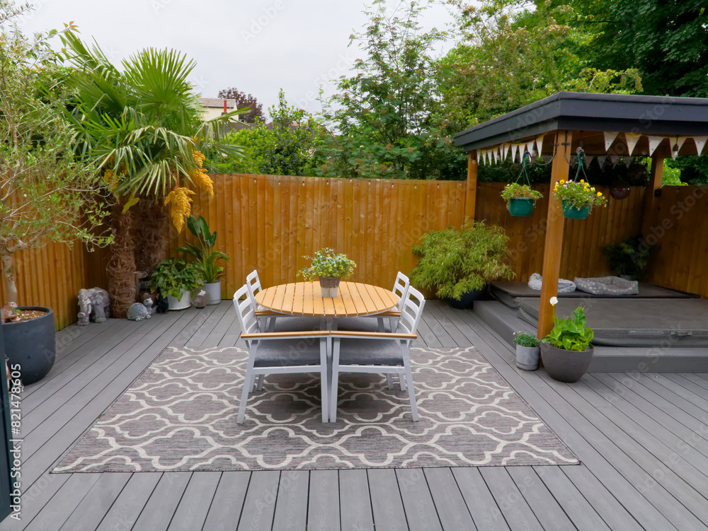 Obraz premium Stylish summer exterior concept with modern house. View of a stylish outdoor wooden floor patio with fantastic forest view. Minimalistic English garden