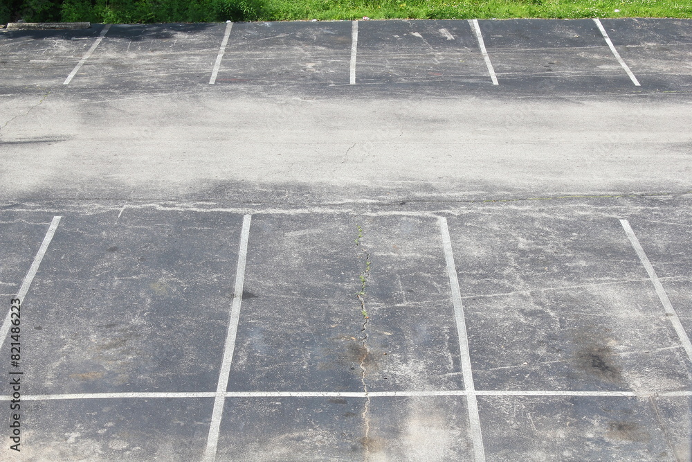 Fototapeta premium car parking lot top view from hotel motels window,asphalt crack rough texture,travel,construction,transport, auto related concept background