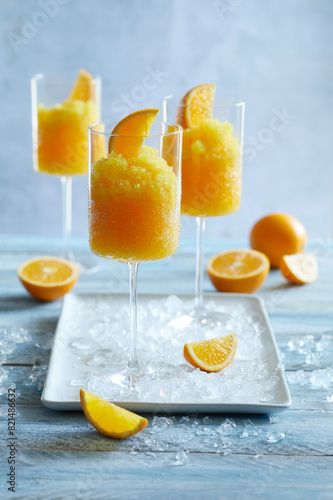 Ice cold orange slushy served in a tall stemmed glass