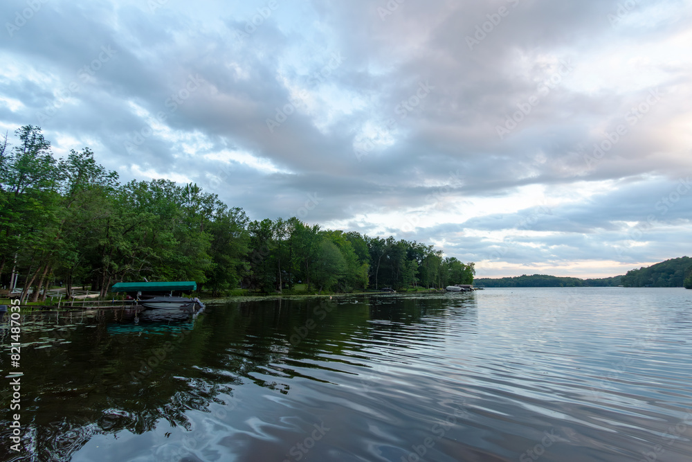 Looking out onto a Wisconsin northwoods lake as the last rays of sunlight begin to fade.  Many boats have returned from fishing for the evening.