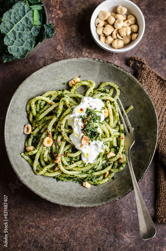 Pasta with kale and hazelnut pesto served with burrata photo