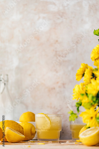 Fresh homemade lemonade, with lemons and flowers. With copy space. photo