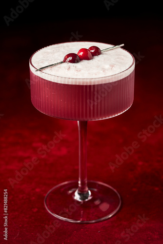 Mulled Wine Sour with Cranberries on Red Surface